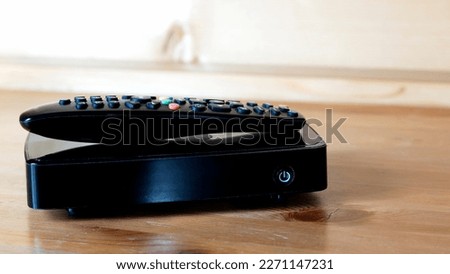 TV set-top box on a wooden background. High quality photo