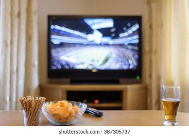 TV, Television Watching (American Football Match) On TV With Snacks And Alcohol - Stock Photo