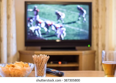 TV, Television Watching (American Football Match) On TV With Snacks And Alcohol - Stock Photo