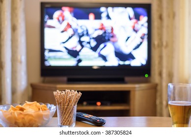 TV, Television Watching (American Football Match) On TV With Snacks And Alcohol - Stock Photo