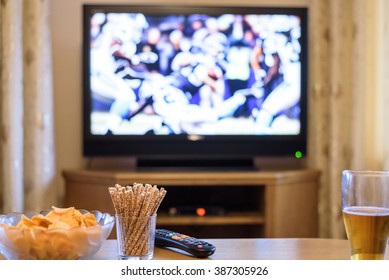 TV, Television Watching (American Football Match) On TV With Snacks And Alcohol - Stock Photo