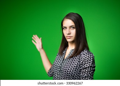  TV Weather News Reporter At Work.News Anchor Presenting The World Weather Report.Television Presenter Recording In A Green Screen Studio.Young Woman With Copy Space On Green Screen Chroma Key