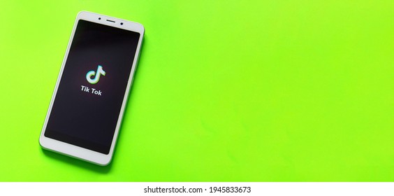 Tver, Russia - February 12, 2020 Tik Tok Logo On Smartphone Screen On Green Background. Tik Tok Icon. Tik Tok Application. Tiktok Social Media Network. Space For Text.