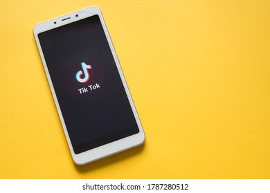 Tver, Russia-February 12, 2020; Tik Tok Logo On A Broken Smartphone Screen On A Yellow Background. Tik Tok Icon. Tick Tok App. Tiktok Social Network. Space For Text.