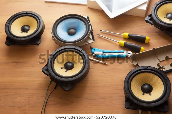 Tweaking audio.\
Audio speakers on a work table. \
