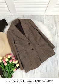 Tweed Jacket With Elbow Patches On A White Wooden Background