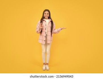 Tween Child In Plaid Shirt Presenting Product. Advertisement. Beauty And Fashion. Latest Trend.