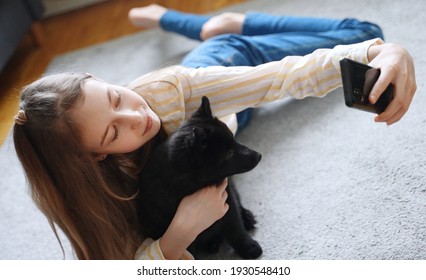 Tween Girl With Her New Puppy Doing Selfie With Smartphone.