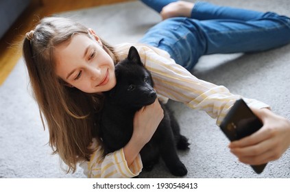 Tween Girl With Her New Puppy Doing Selfie With Smartphone.