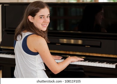 Tween Girl Playing The Piano With Hands On Keyboard