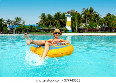 Tween Girl Relaxing On The Inflatable Ring In The Water Park In Thailand