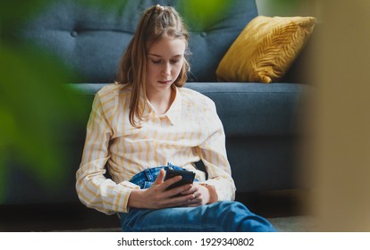 Tween Girl With Smartphone At Home.