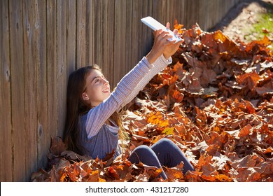 Tween Kid Girl Selfie Tablet Pc In Autumn Leaves Park