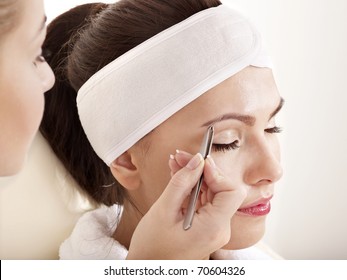 Tweezing Eyebrow By Beautician. Isolated.