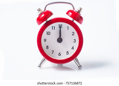 Twelve is on a small red clock, isolated on white - Shutterstock ID 757136872