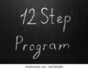 Twelve Step Program Written In White Chalk On A Black Chalkboard.