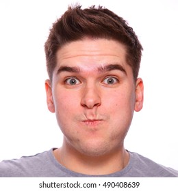 Twenty Something Brown Haired Man Holding Breath With Pursed Lips Headshot