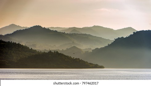 Twilight before sunrise on the ocean coast. Ocean and mountains Landscape at the foggy morning. Komodo Island. Moluccas, Indonesian Maluku, Spice Islands, Indonesian islands, Malay Archipelago.