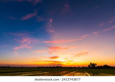 Twilight blue bright and orange yellow dramatic sunset sky in countryside or beach colorful cloudscape texture with white clouds air background. Stock-foto