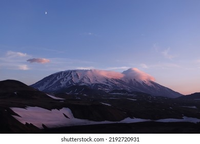 Twilight in Kamchatka. The moon hovered over the volcano Flat Tolbachik. Mountains in the sunset light. Hiking in the wilderness - Shutterstock ID 2192720931