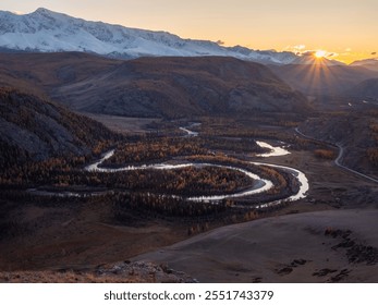 Twilight in a mountain valley with a twisty river. Amazing autumn top view on the of the valley with a winding river, forest, golden trees and mountains on the background of the evening sky at sunset. - Powered by Shutterstock