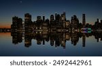 Twilight shot of New York city Skyline by night out of focus with bokeh with wide angle looking towards downtown Manhattan