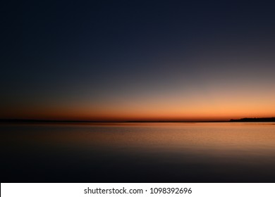 Twilight sky over the lake in the beautiful colors of the sunset afterglow - Powered by Shutterstock