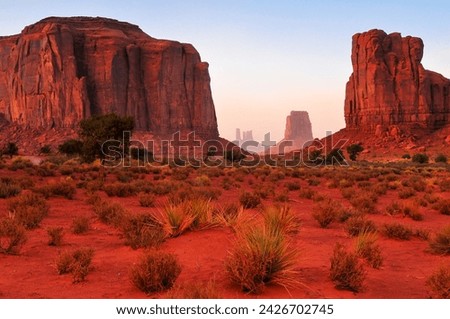 Twilight view of the North Window, between Elephant Butte and Cly Butte, towards East Mitten Butte and other spires and towers of Monument Valley Navajo Tribal Park, Arizona, Southwest USA.