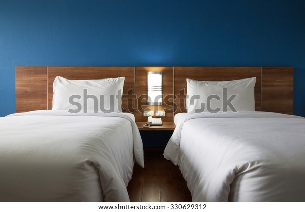 Twin bed with wood\
headboard.