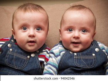 Twin boys in overalls looking at the camera