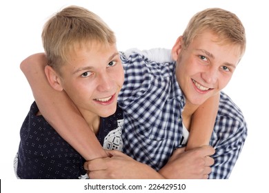 Twin brothers are joking and hugging each other