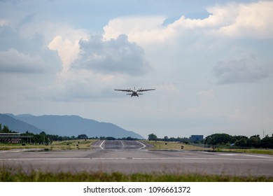 Twin Engines Propeller Aircraft Take Off From Runway And Climb With Cloud And Sky Background And Copy Space