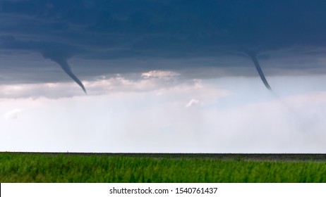 Twin Funnel Clouds From Landspout Tornadoes Beneath A Storm In Kansas