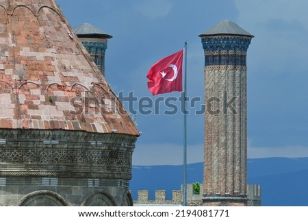 Twin Minaret Madrasah and Turkish flag in Erzurum , Turkey - The madrasah was built in 1271 by Khudavand Khatun, the daughter of Seljuq Sultan Kayqubad I. 