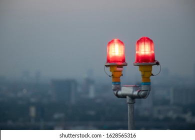 Twin Red  Obstruction Light On Rooftop Tower At Sunset.