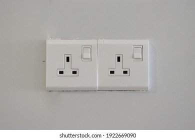 A Twin UK 3-pin Wall Socket On White Background. Malaysian Wall Socket. Wall Plug