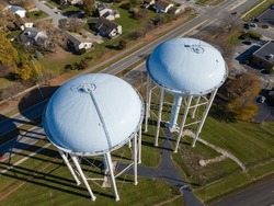 Twin Water Towers Stand Over Upper Arlington, OH, With A Suburban Backdrop.