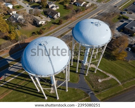 Twin water towers stand over Upper Arlington, OH, with a suburban backdrop.