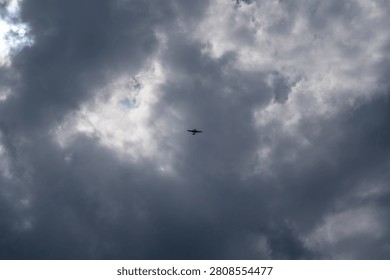 A twin-engine light aircraft flying through a cloudy sky. Aviation scene featuring a small private airplane above the clouds, representing general aviation, flight training, air travel and aircraft technology.