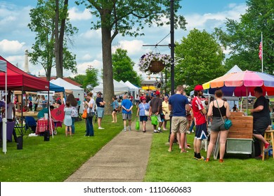 TWINSBURG, OH - JUNE 9, 2018: Visitors gather around vendor booths for A Taste of Twinsburg, an outdoor culinary and arts festival held one Saturday in summer on the town square.