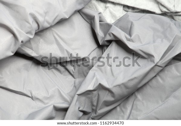 Twisted folded fabric - a cover of protection of\
the car from a rain, snow,\
water.