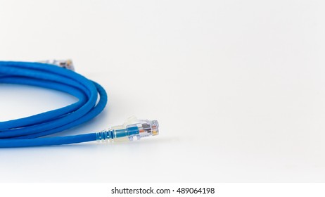 Twisted pair (patch cord) blue network Internet cable with shadow isolated over white background