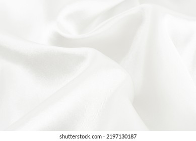 A twisted piece of white fabric. White material or texture with waves and folds. Wrinkled white fabric - Shutterstock ID 2197130187