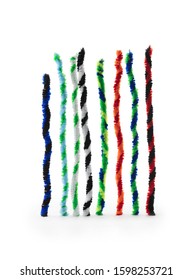 Twisted pipe cleaners in two tone twists, isolated on white, standing up like bar graphs.