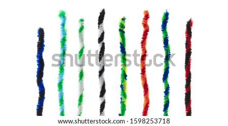 Twisted pipe cleaners in two tone twists, isolated on white, standing up like bar graphs. 