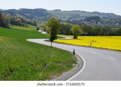 Twisted Road Through The Yellow Spring Fields In The Eifel