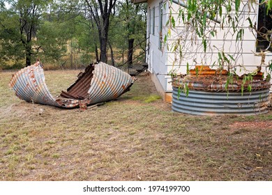 A Twisted Sheet Of Corrugated Iron Abandoned In A Back Yard