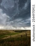 Twisted skies in Nebraska unleash rain over the farmlands in the Great Plains.