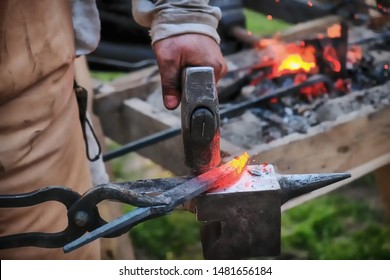 Twisting a red-hot billet is clamped in the grip. Blacksmith twists a hot rod on the anvil. - Powered by Shutterstock