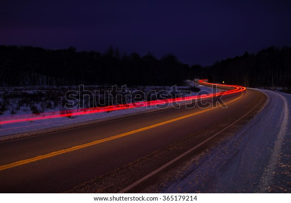 A twisting road at night\
time
